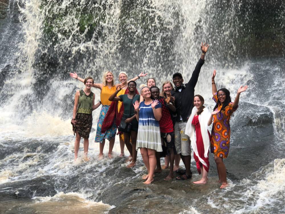 students playing in waterfall